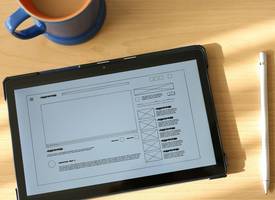 Accessible placeholder image with alt text displayed on a tablet near code