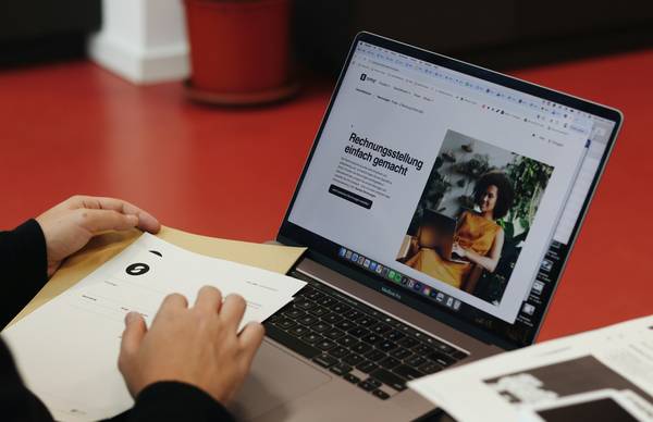 Web designers reviewing accessible, high-contrast placeholder images on a laptop