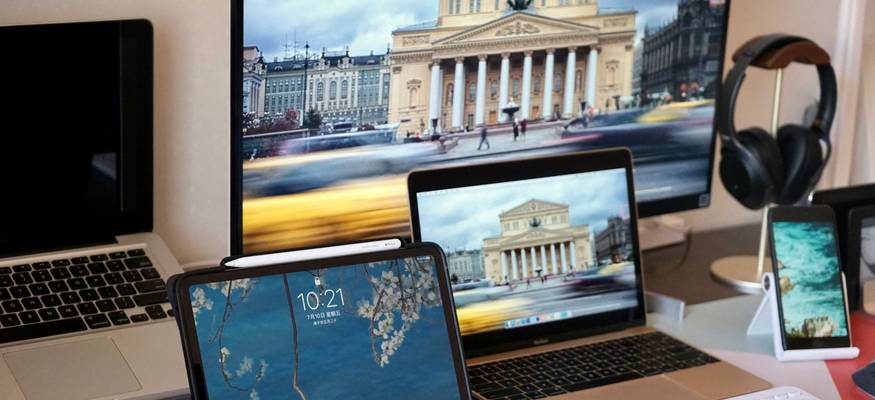 A team of app developers collaborating on laptops with placeholder images on screen